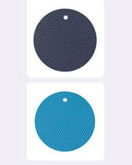 Two circular adhesive pads with a honeycomb pattern, shown vertically on white cards against a light gray background. The top pad is dark navy blue, and the bottom pad is bright blue.